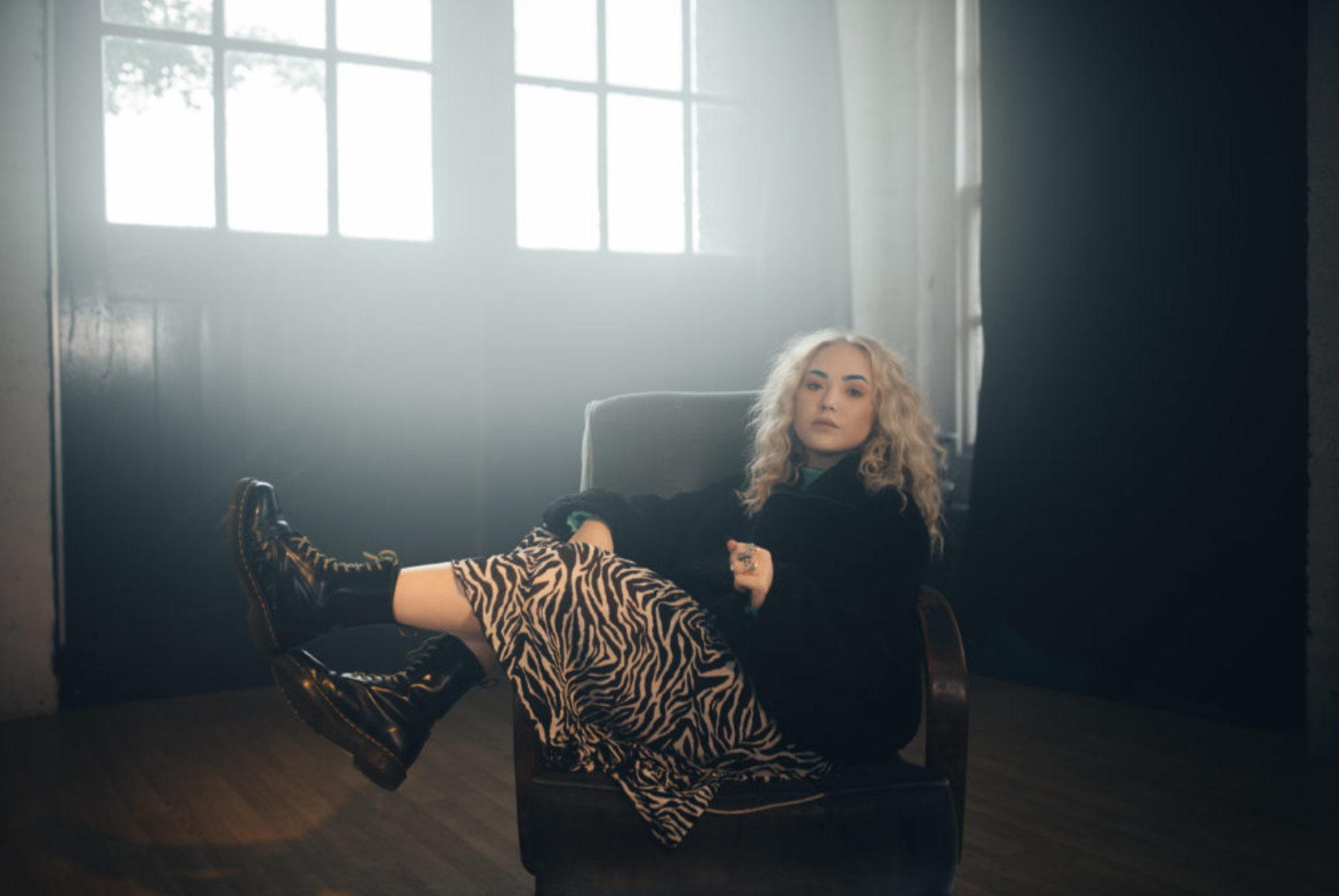 Millie Page reclining in a studio chair